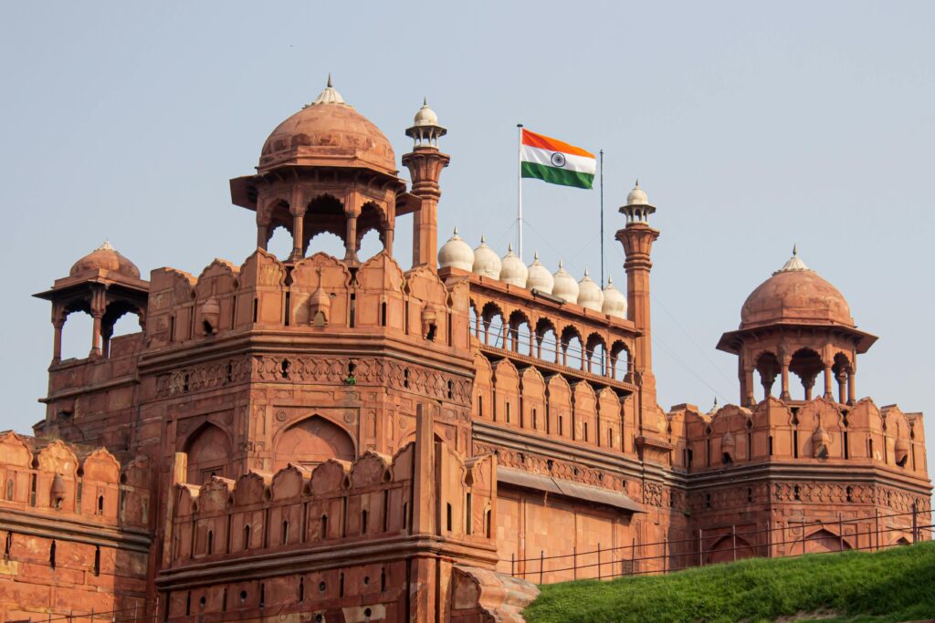 Front view of the historic Red Fort in New Delhi with the Indian flag waving.